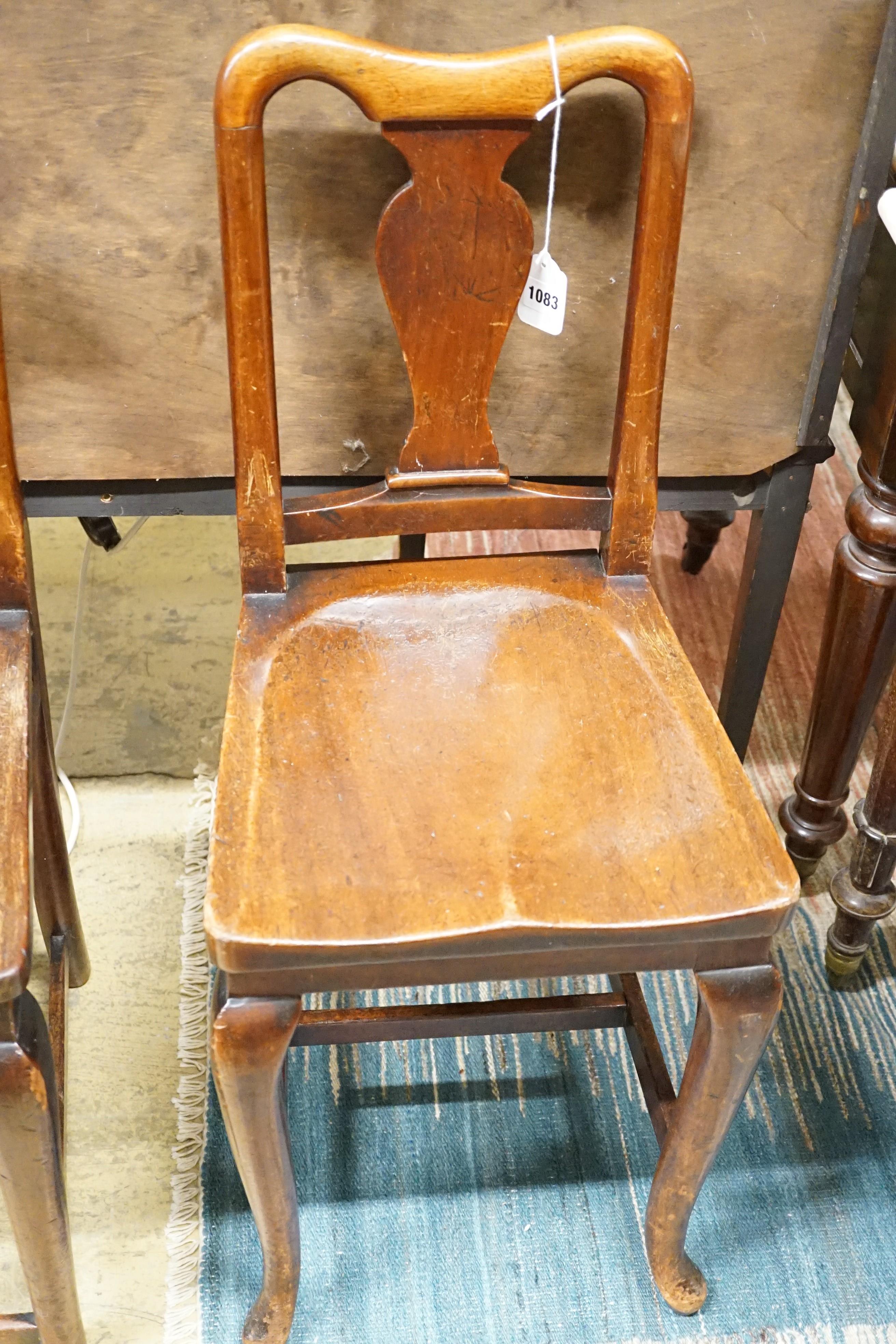 A pair of mahogany hall chairs, (one cut down)